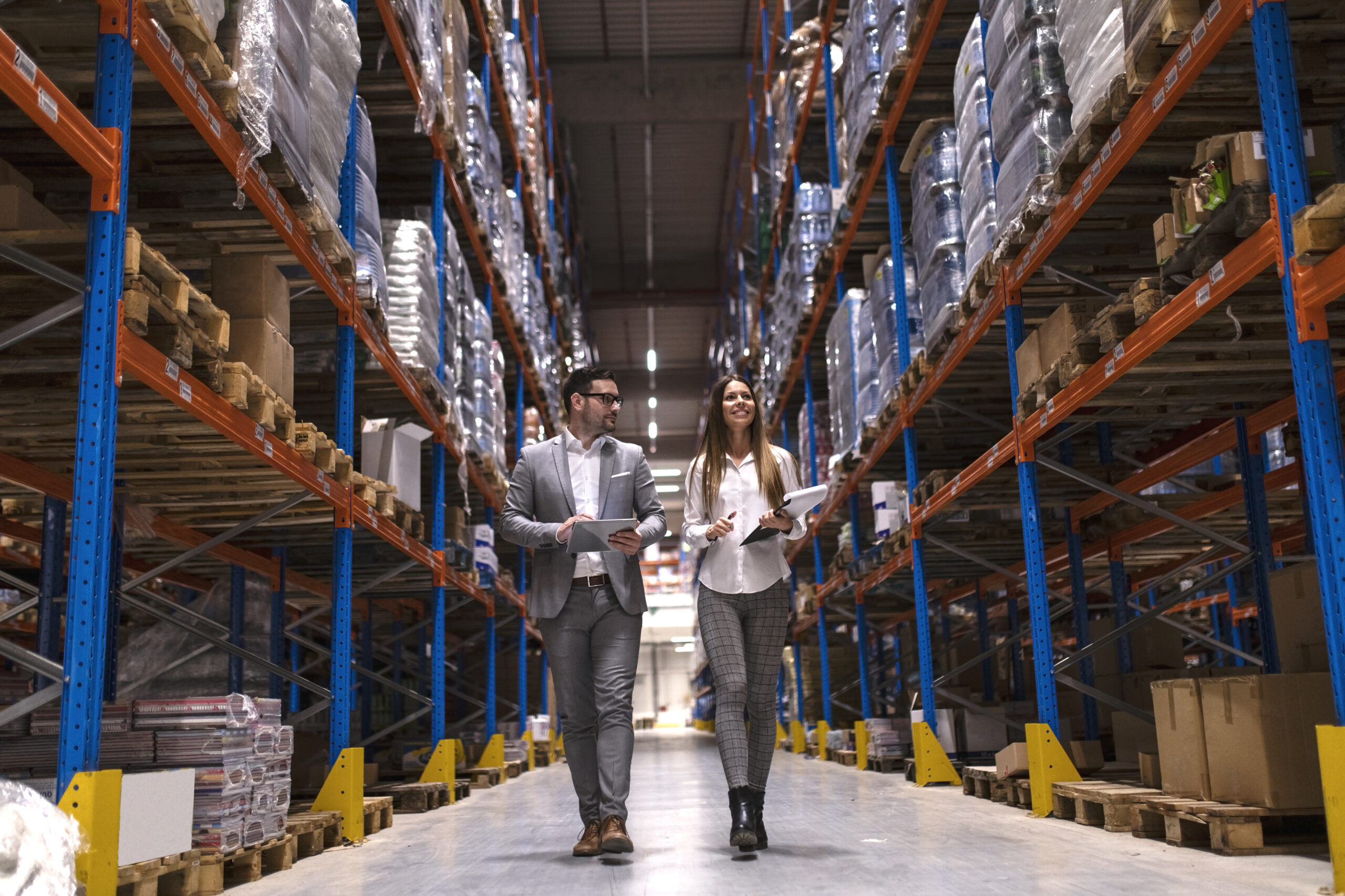 warehouse managers walking through large distribution center.